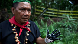Emergildo Criollo displays oil waste left by the American company Texaco