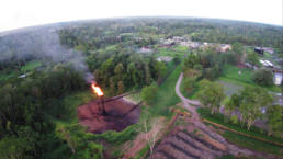 A gas flaring tower, one of hundreds, burns 24 hours a day