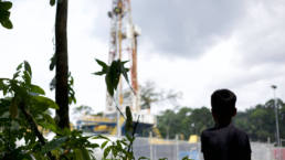 A boy looks out at an oil platform in Secoya territory